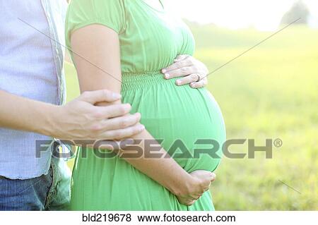 Close up of Caucasian man hugging pregnant wife View Large Photo Image Stock Photo - Close up of Caucasian man hugging pregnant wife. Fotosearch