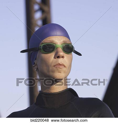 Stock Photo - Close up of Caucasian swimmer wearing goggles and wetsuit. Fotosearch