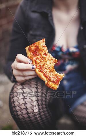 Close up of Caucasian woman eating pizza outdoors View Large Photo Image Stock Photography - Close up of Caucasian woman eating pizza outdoors. Fotosearch