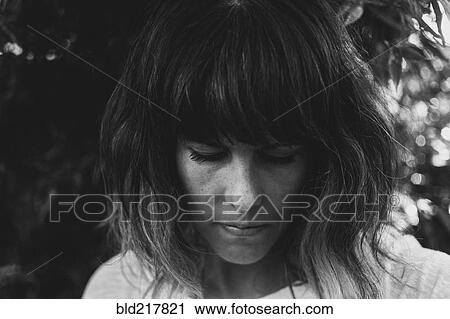 Stock Image - Close up of Caucasian woman looking down. Fotosearch