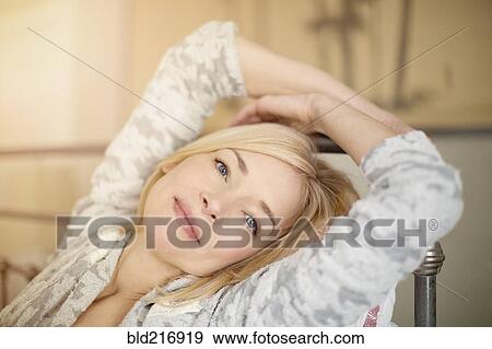 Close up of Caucasian woman relaxing on bed View Large Photo Image Stock Photo - Close up of Caucasian woman relaxing on bed. Fotosearch
