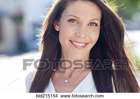 Picture - Close up of Caucasian woman smiling outdoors. Fotosearch
