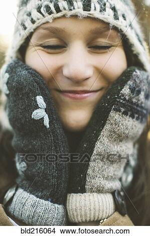 Picture - Close up of Caucasian woman wearing knitted cap and gloves. Fotosearch