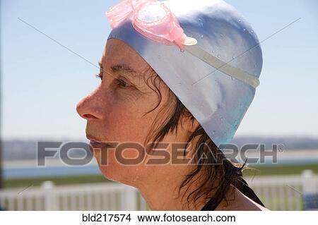 Picture - Close up of Caucasian woman wearing swim cap and goggles. Fotosearch