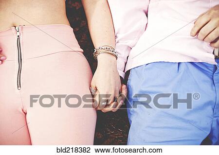 Close up of couple holding hands View Large Photo Image Stock Image - Close up of couple holding hands. Fotosearch