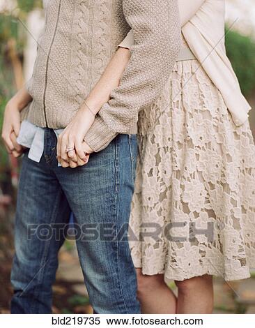 Stock Photography - Close up of couple hugging in backyard. Fotosearch