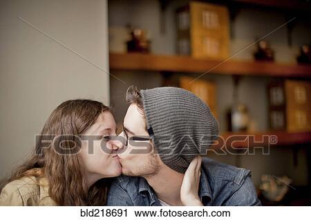 Stock Image - Close up of couple kissing. Fotosearch