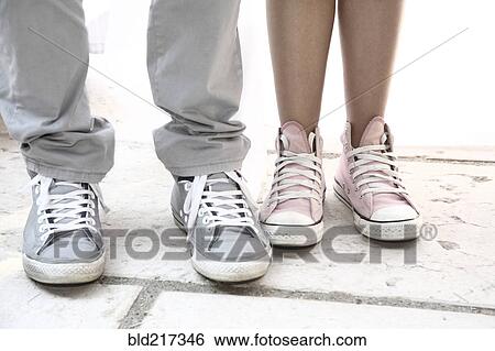 Close up of couple wearing sneakers View Large Photo Image Stock Photograph - Close up of couple wearing sneakers. Fotosearch