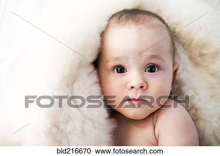 Stock Image - Close up of curious mixed race baby. Fotosearch