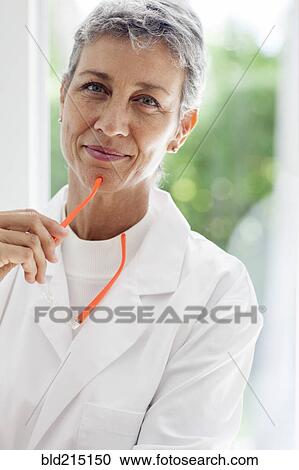 Close up of doctor holding eyeglasses View Large Photo Image Stock Image - Close up of doctor holding eyeglasses. Fotosearch