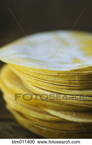 Stock Image - Close up of dumpling wrappers in a stack. Fotosearch