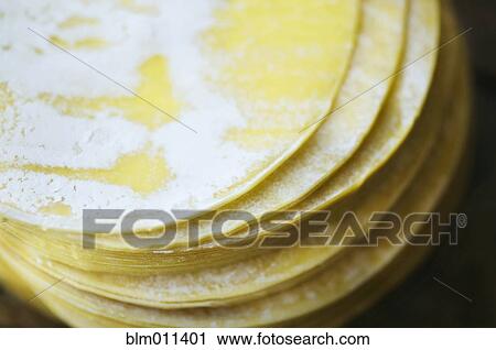Stock Image - Close up of dumpling wrappers in a stack. Fotosearch