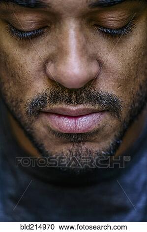 Close up of face mixed race man looking down View Large Photo Image Stock Image - Close up of face mixed race man looking down. Fotosearch