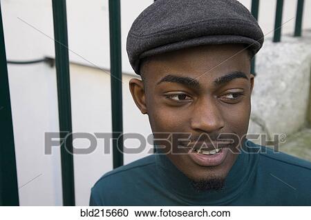 Stock Image - Close up of face of curious Black man. Fotosearch