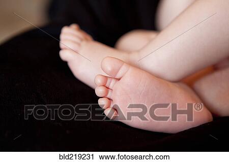 Stock Image - Close up of feet of baby boy. Fotosearch