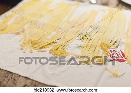 Stock Image - Close up of fresh pasta on cloth. Fotosearch