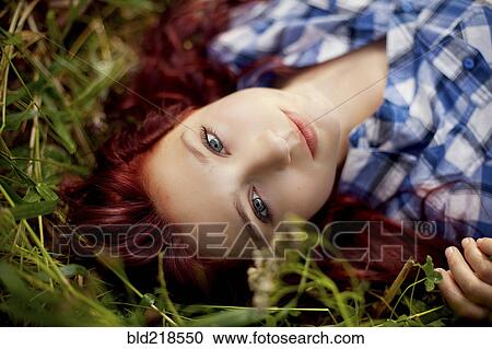 Close up of girl laying in grass View Large Photo Image Stock Image - Close up of girl laying in grass. Fotosearch