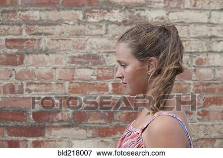 Close up of girl near brick wall View Large Photo Image Stock Photo - Close up of girl near brick wall. Fotosearch