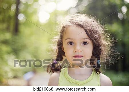 Close up of girl standing in forest View Large Photo Image Stock Photo - Close up of girl standing in forest. Fotosearch
