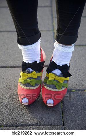 Stock Image - Close up of girl wearing bows on shoes. Fotosearch