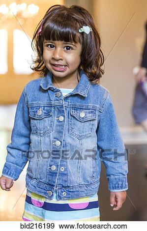 Stock Photo - Close up of girl wearing denim jacket. Fotosearch