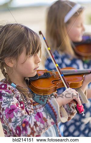 Close up of girls playing violin View Large Photo Image Stock Image - Close up of girls playing violin. Fotosearch