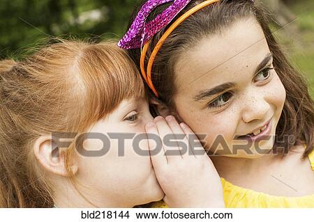 Close up of girls whispering outdoors View Large Photo Image Picture - Close up of girls whispering outdoors. Fotosearch