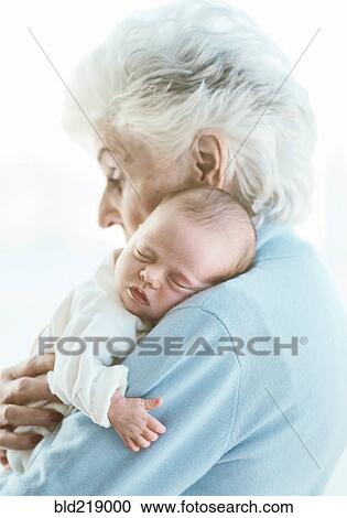 Stock Image - Close up of grandmother holding grandson. Fotosearch