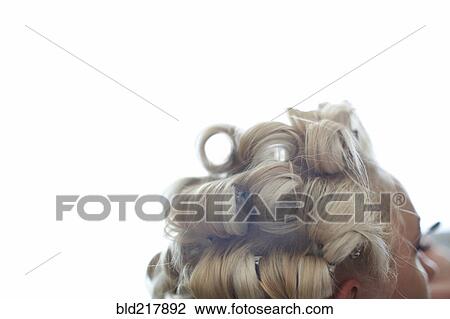 Stock Image - Close up of hair of Caucasian woman in rollers. Fotosearch
