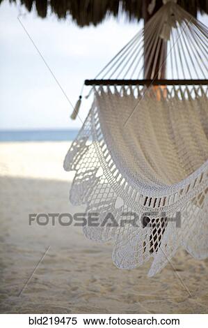 Stock Photography - Close up of hammock hanging on tropical beach. Fotosearch