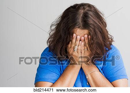 Close up of Hispanic woman covering face with hands View Large Photo Image Stock Image - Close up of Hispanic woman covering face with hands. Fotosearch