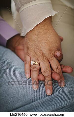Close up of husband and wife holding hands View Large Photo Image Stock Image - Close up of husband and wife holding hands. Fotosearch