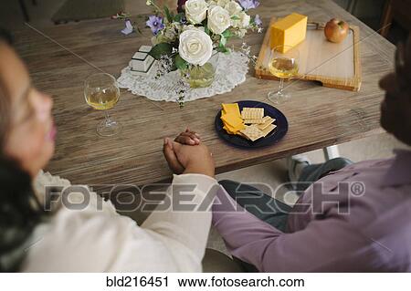 Stock Image - Close up of husband and wife holding hands. Fotosearch