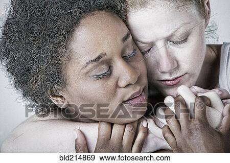 Close up of intense lesbian couple hugging View Large Photo Image Stock Photo - Close up of intense lesbian couple hugging. Fotosearch