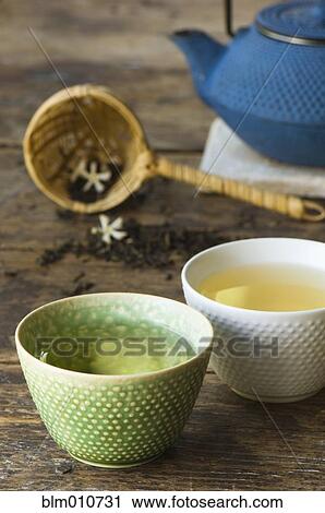 Stock Image - Close up of jasmine tea in teacups. Fotosearch