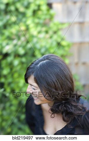 Stock Photo - Close up of laughing woman in backyard. Fotosearch