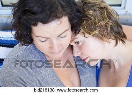Close up of lesbian couple hugging View Large Photo Image Stock Photo - Close up of lesbian couple hugging. Fotosearch