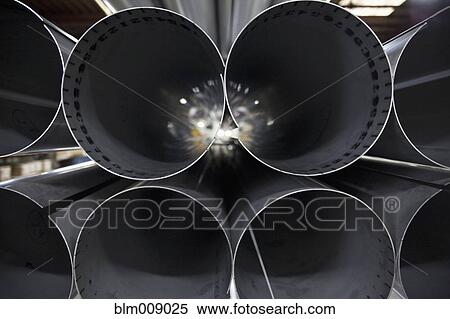 Stock Photography - Close up of metal pipes stacked together. Fotosearch