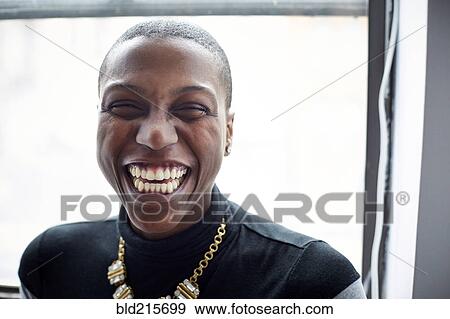 Stock Photo - Close up of mixed race woman laughing,. Fotosearch