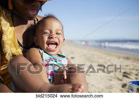 Picture - Close up of mother and daughter playing on beach. Fotosearch