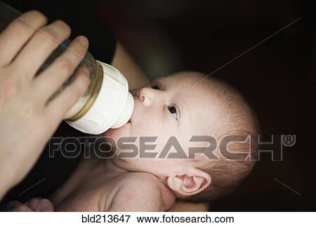 Stock Photo - Close up of mother feeding newborn baby. Fotosearch