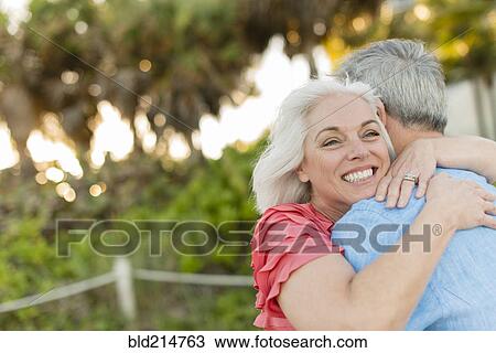 Stock Image - Close up of older Caucasian couple hugging. Fotosearch