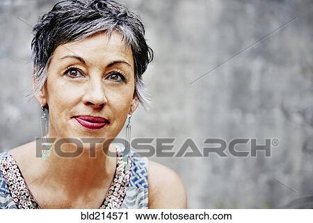 Stock Image - Close up of older Caucasian woman sitting outdoors. Fotosearch