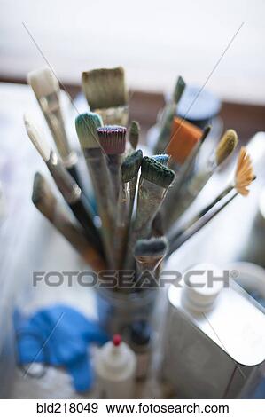 Stock Photo - Close up of paintbrushes in jar. Fotosearch