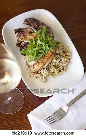 Close up of plate of fish dinner with white wine View Large Photo Image Stock Photo - Close up of plate of fish dinner with white wine. Fotosearch