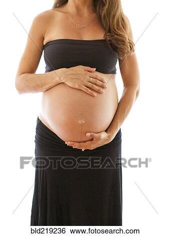 Close up of pregnant Caucasian woman holding belly View Large Photo Image Stock Photograph - Close up of pregnant Caucasian woman holding belly. Fotosearch