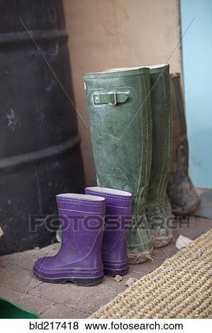 Close up of rain boots of adult and child View Large Photo Image Stock Photo - Close up of rain boots of adult and child. Fotosearch