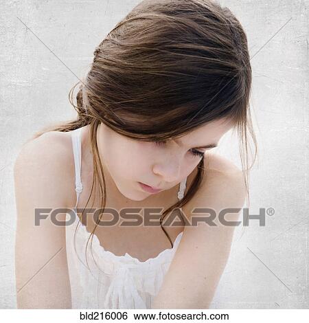 Stock Photograph - Close up of sad girl looking down. Fotosearch