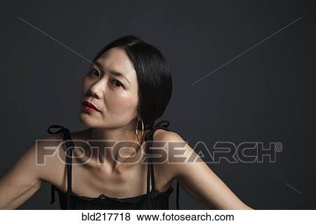 Stock Photo - Close up of serious Asian woman. Fotosearch