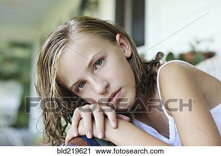 Close up of serious girl leaning in armchair View Large Photo Image Stock Image - Close up of serious girl leaning in armchair. Fotosearch